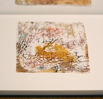 Batik fabric experiment based on salvaged wash basin. Image: Mary Grieve Piece of artwork replicating the texture of cracked glaze on pottery. A white base with red, brown and yellow coloured prints in the lines and shapes inspired by the cracked glaze.