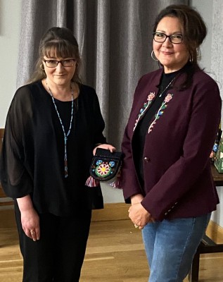 Cynthia presenting her beadwork piece to Janette for the Museum collection. Cynthia presenting her beadwork piece to Janette for the Museum collection.